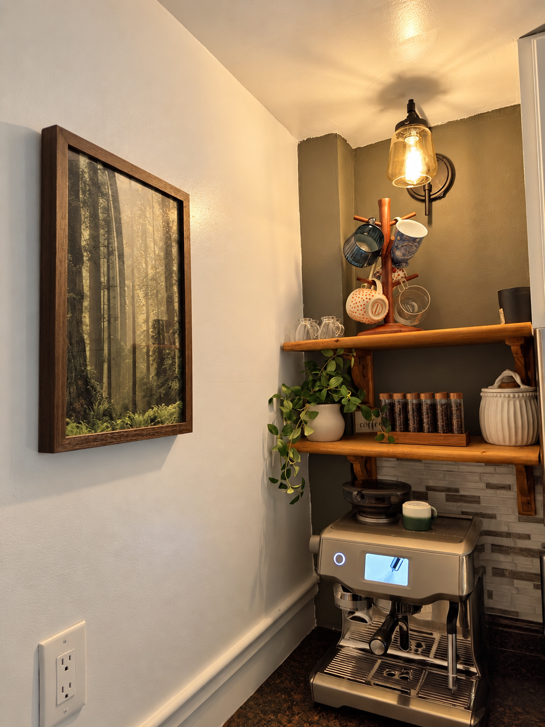 After: two open wood shelves with a trailing plant, mugs and a warm wall light above the espresso machine